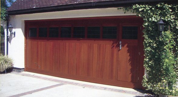 Photo of a double door with wicket on heavy-duty retractable lifting gear. 